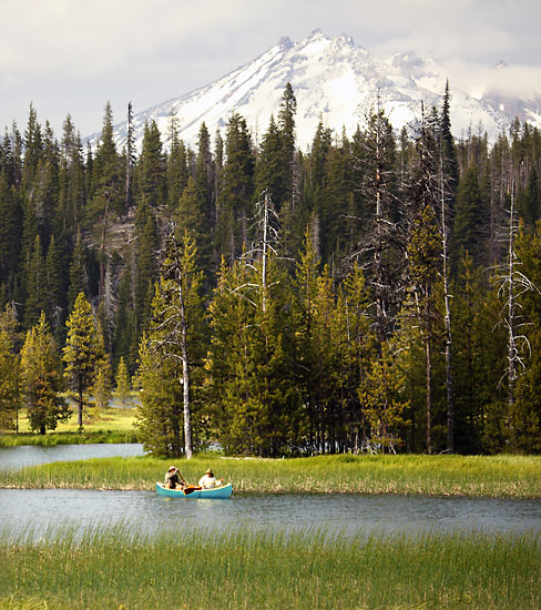 Canoeing on Hosmer Lake, Cascade Mountains, Oregon photographer David Whitten